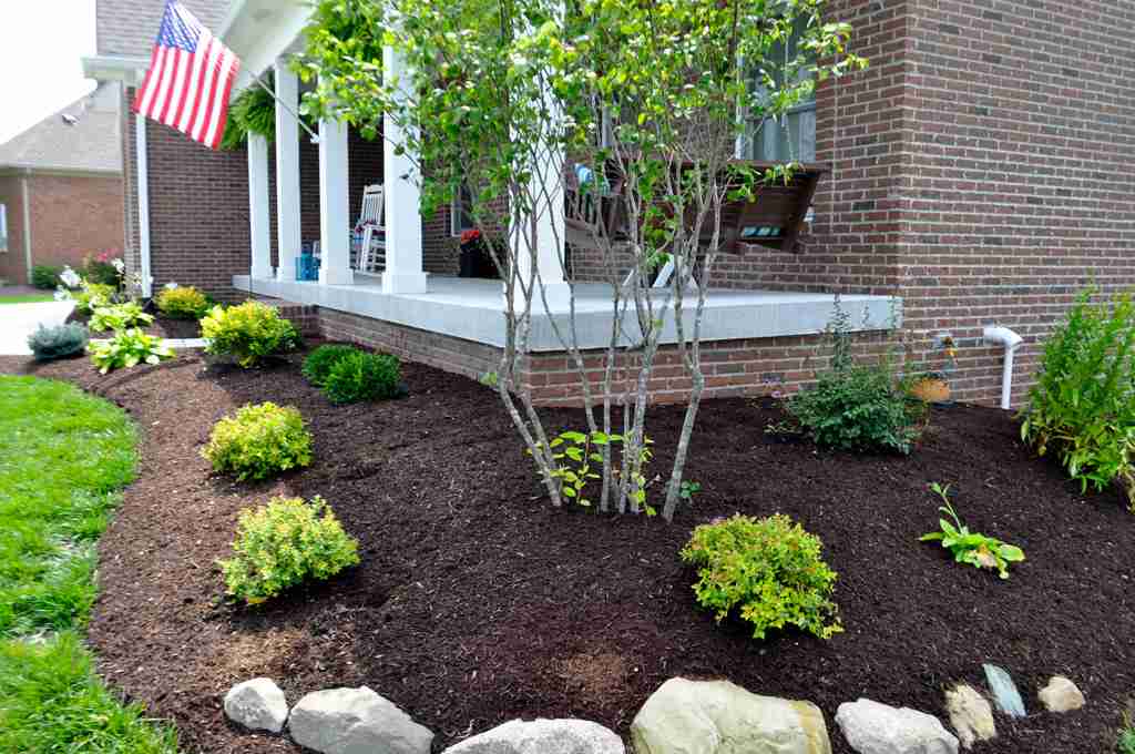 Hardwood mulch is placed on the front porch.