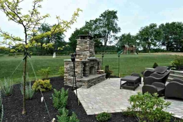 Outdoor kitchen with pizza oven. New landscape care